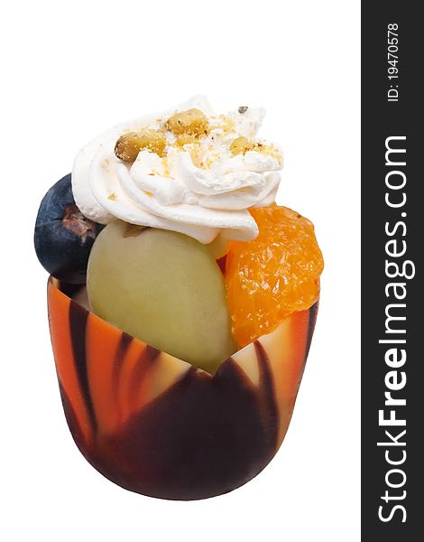Parfait in a decorative chocolate shell with fruits and whipped cream. Parfait in a decorative chocolate shell with fruits and whipped cream