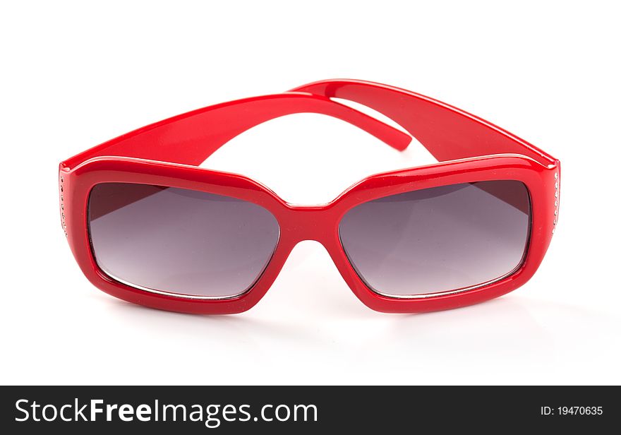One red sunglasses on the white background. One red sunglasses on the white background