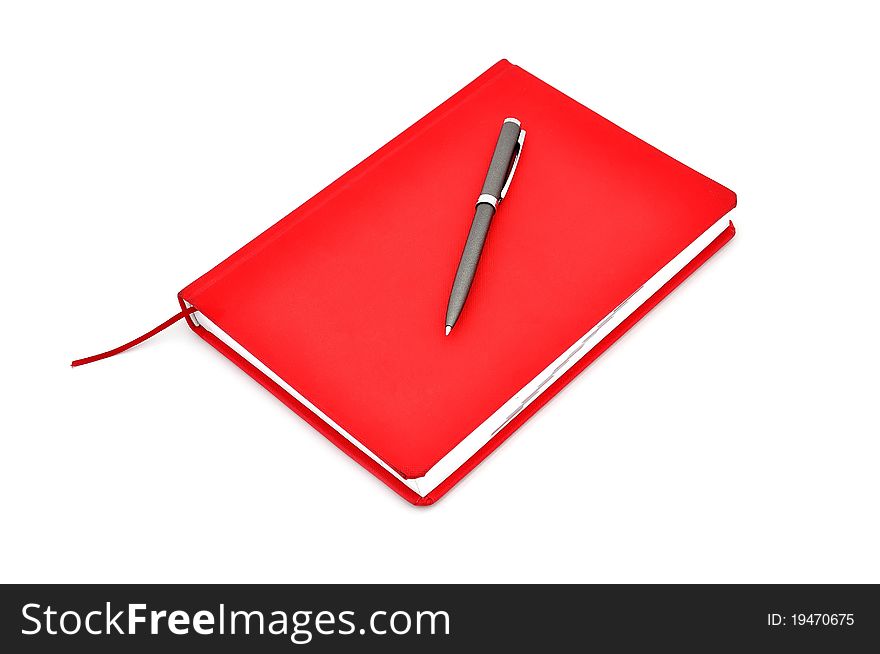 Red diary and pen on a white background