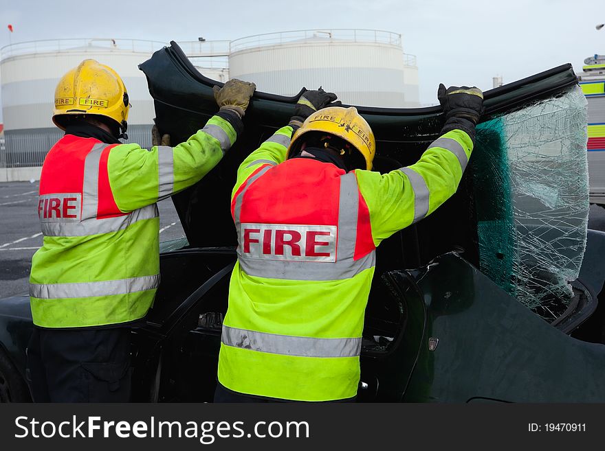 Fire and Rescue emergency Units at car accident removing brocken wind screen. Fire and Rescue emergency Units at car accident removing brocken wind screen