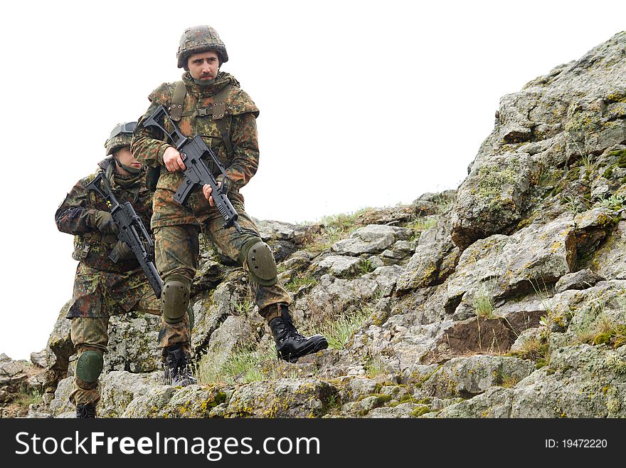 Two heavy equiped military men walking with weapons. Two heavy equiped military men walking with weapons