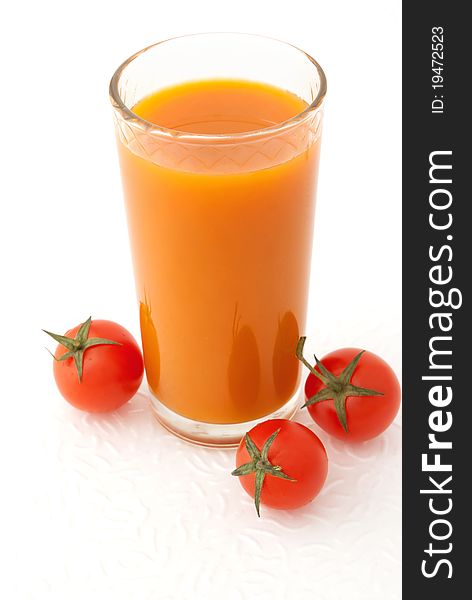 Glass of vegetable juice and fresh tomatoes on white background. Glass of vegetable juice and fresh tomatoes on white background