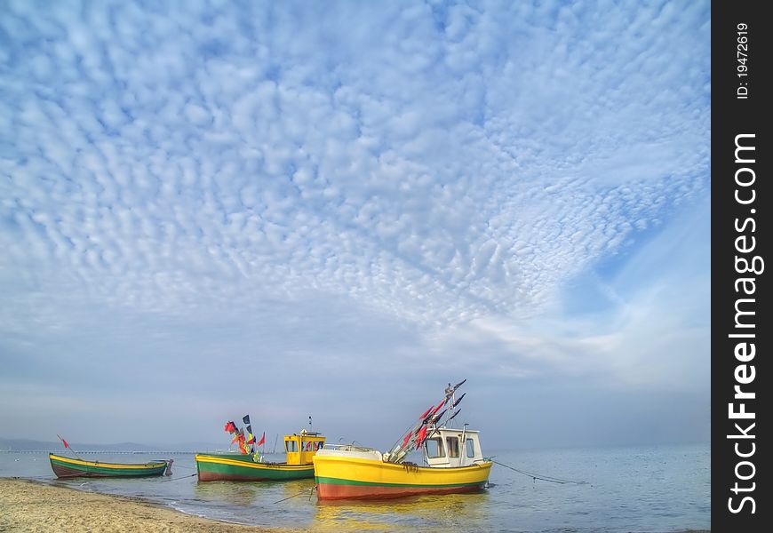 Tree fishing boats on the beach, Poland