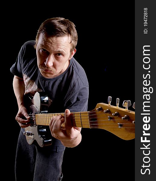 Color photo of a man with an electric guitar in his hands. Color photo of a man with an electric guitar in his hands