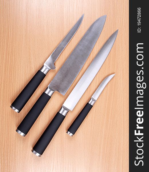 Color photograph of kitchen knives on board. Color photograph of kitchen knives on board