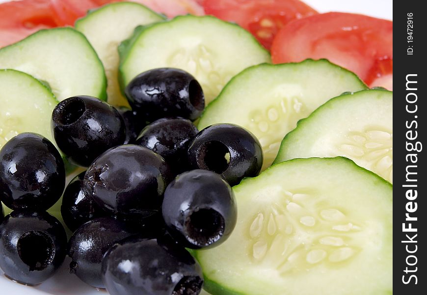 Color photograph of sliced tomatoes and cucumbers on a plate. Color photograph of sliced tomatoes and cucumbers on a plate