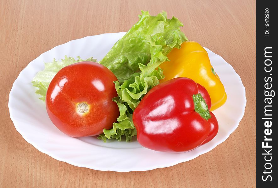 Color photograph of tomatoes and peppers on a plate