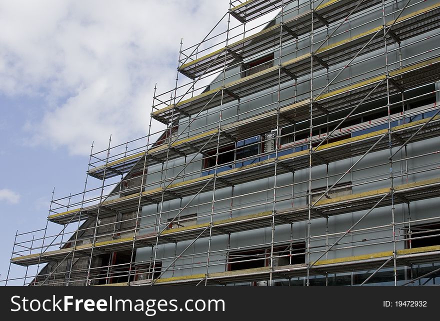 Construction of new building with clouds on background