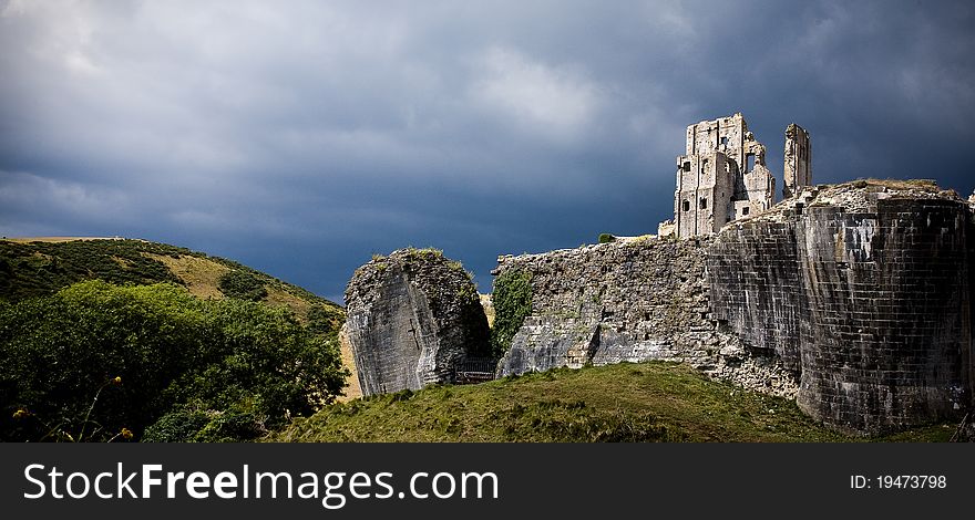 A photograph of castle ruins on a hill side