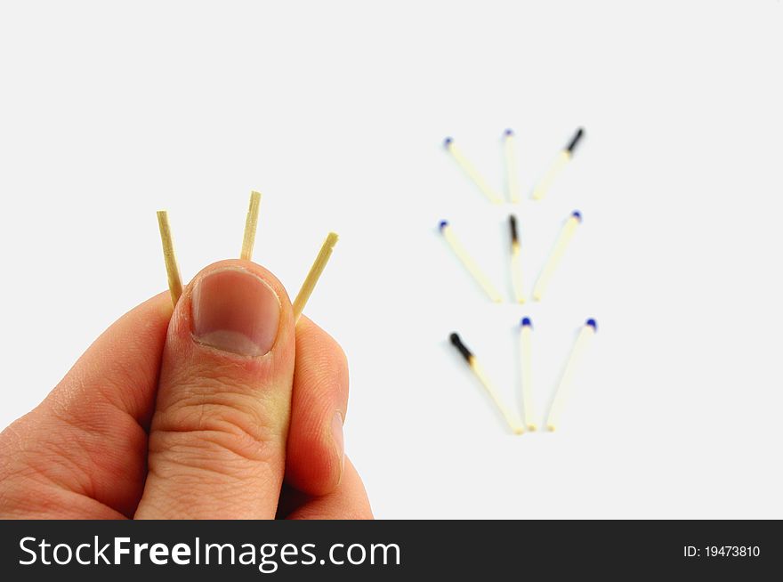 A hand is holding three matches. The concept: â€œchoose oneâ€. One of three is marked, guess which one. A hand is holding three matches. The concept: â€œchoose oneâ€. One of three is marked, guess which one.