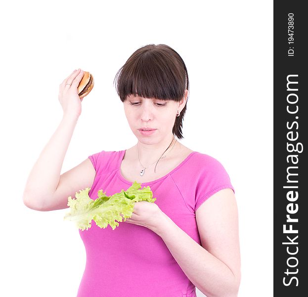 The young woman throws out a hamburger holding salad