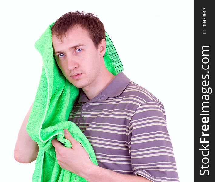 The young man wipes a head a terry towel
