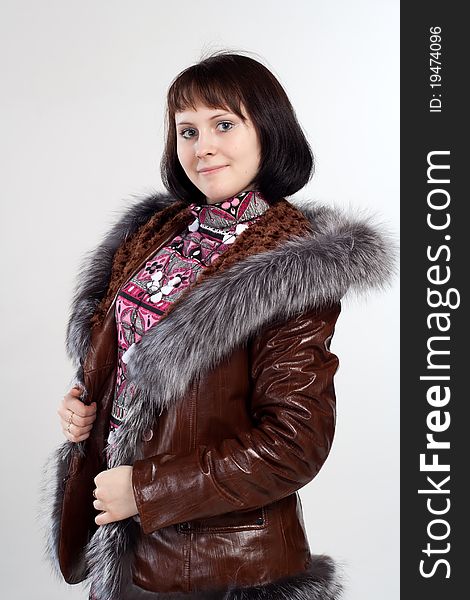 Young woman posing in cout with fur neck. Young woman posing in cout with fur neck