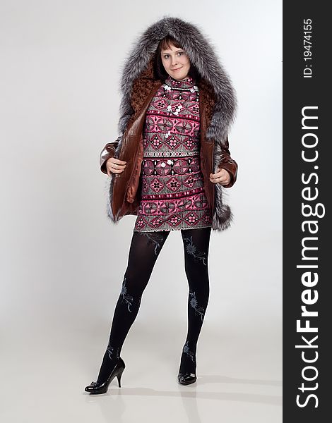 Youth Woman Staning In Coat With Fur Neck Isolated