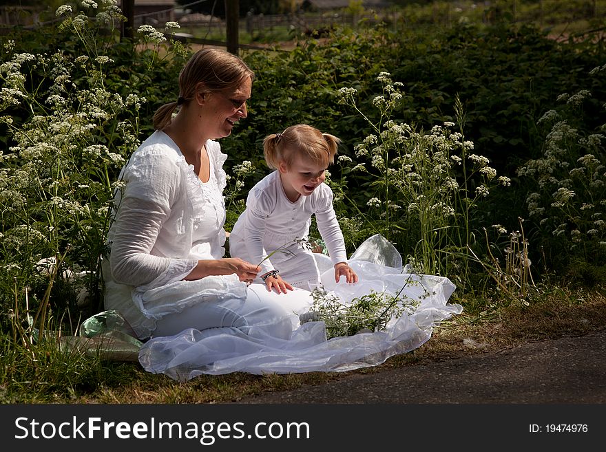 Mother and child between the white flowers. Mother and child between the white flowers