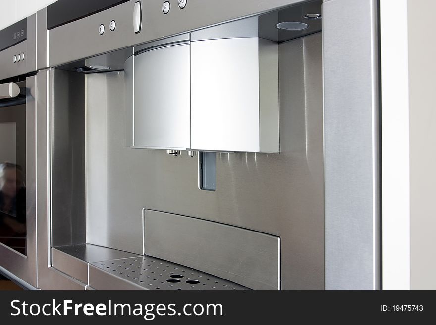Coffee maker in stainless steel built into the kitchen units. Coffee maker in stainless steel built into the kitchen units