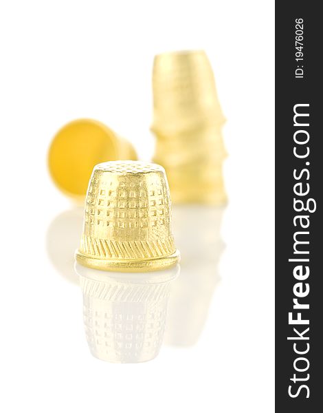 Composition of golden Thimbles isolated on white background