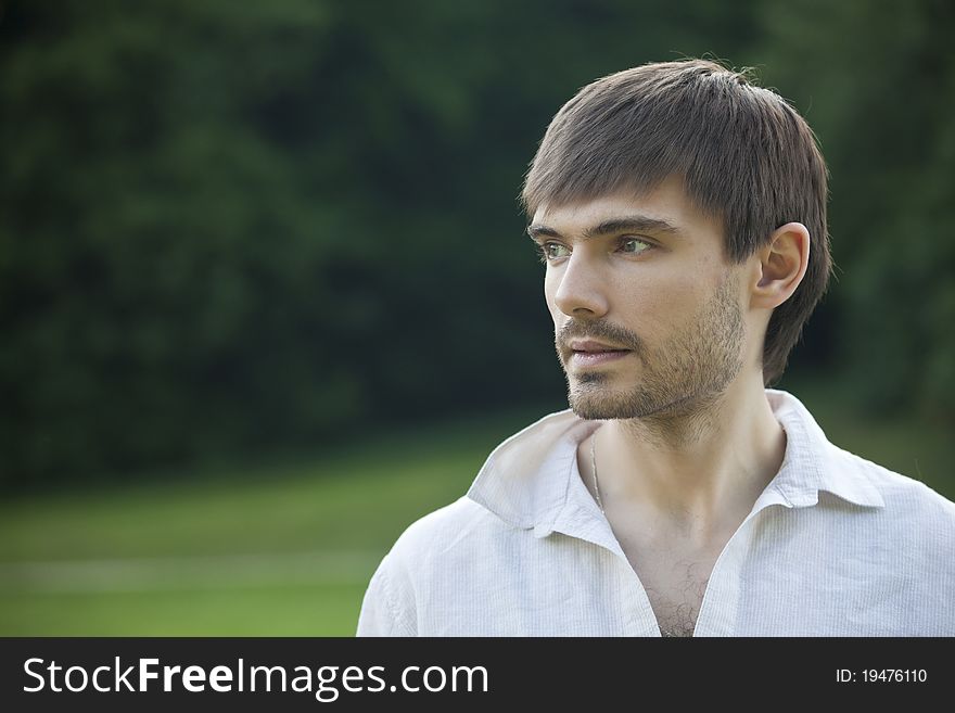 Portrait of relaxed man in linen shirt in park. Portrait of relaxed man in linen shirt in park