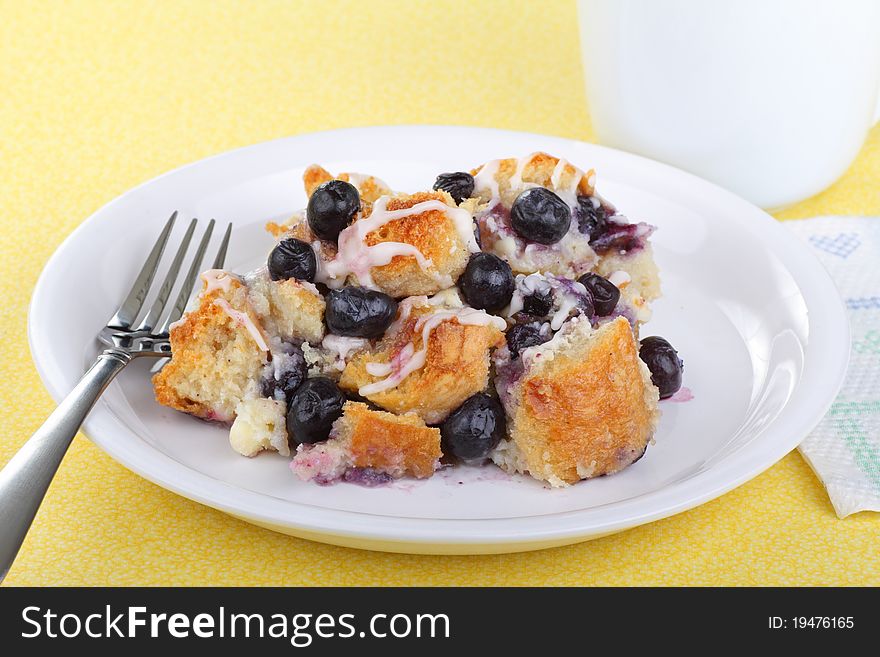 Plate of blueberry bread pudding with cup