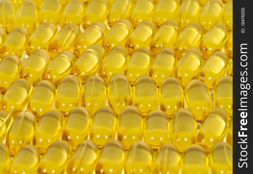 Fishoil capsules close up as background