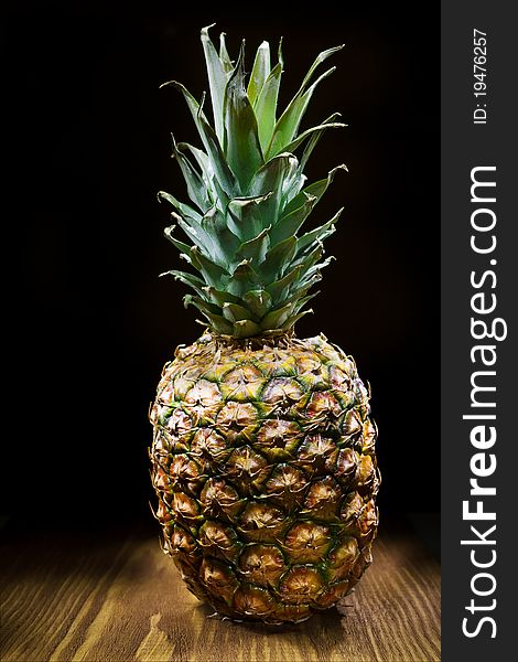 One Pineapple On Wooden Board