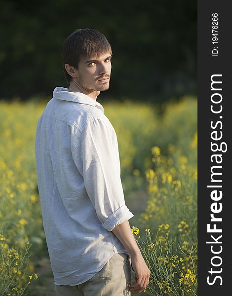 Portrait of man in linen clothes standing in field. Portrait of man in linen clothes standing in field