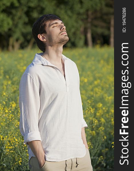 Man standing in field and enjoying the sunset. Man standing in field and enjoying the sunset