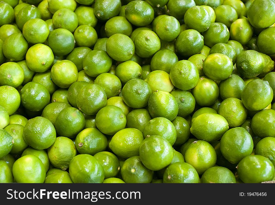 Fresh green limes bunched together at a farm stand. Fresh green limes bunched together at a farm stand