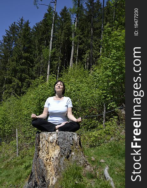 Senior woman practicing yoga in the forest. Senior woman practicing yoga in the forest.