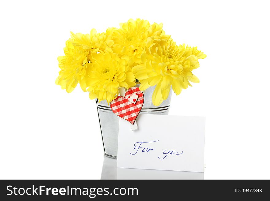 Yellow chrysanthemums in a bucket with chrysanthemums next card with the text for you and a pin with a red heart. Isolated. Yellow chrysanthemums in a bucket with chrysanthemums next card with the text for you and a pin with a red heart. Isolated