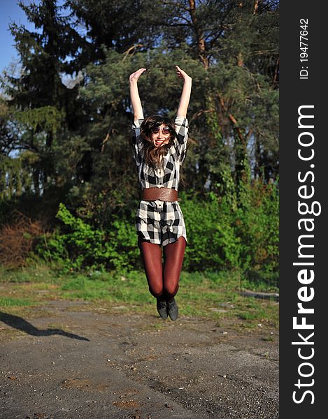 Portrait with happy young woman jumping