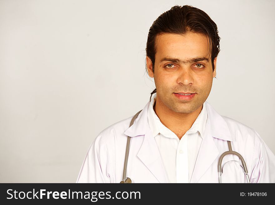 A portrait of a medical doctor posing against white background