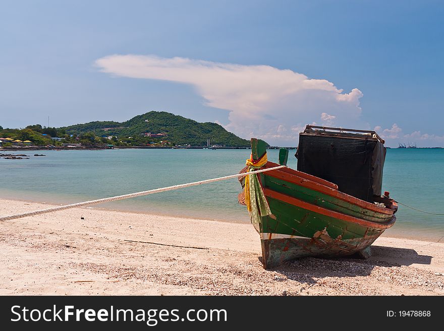 Wooden boat on the beach with blue sky