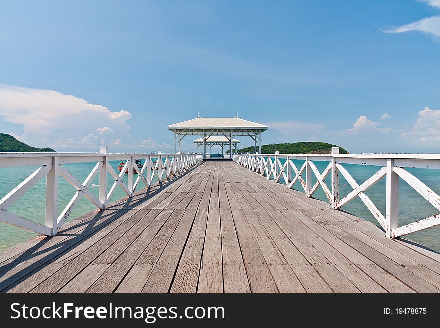 White bridge in to the sea with blue sky