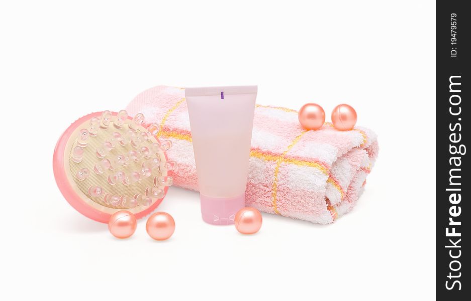 Massager, cream tube and towel on white background. Massager, cream tube and towel on white background