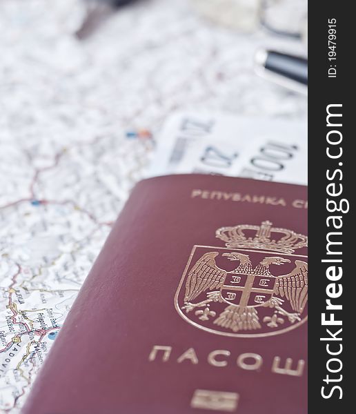 A closeup picture of an serbian passport. Map background , vertical composition. A closeup picture of an serbian passport. Map background , vertical composition