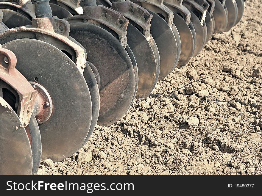 Harrow. Agricultural machinery. Cultivation of land. Metal discs to break ground. Sowing time. Harrow. Agricultural machinery. Cultivation of land. Metal discs to break ground. Sowing time.