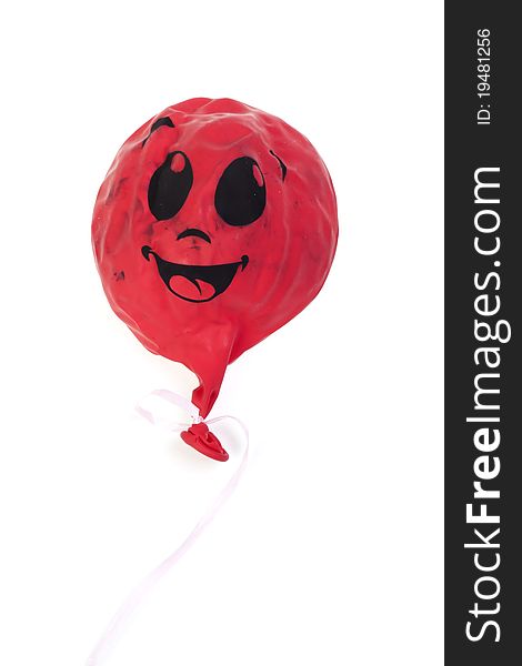 The red lowered sphere on a white background with the smilie image. The red lowered sphere on a white background with the smilie image