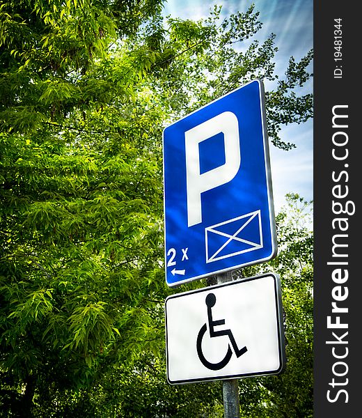 Parking place sign for disabled in sun rays