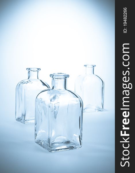 Several glass bottles against a light background