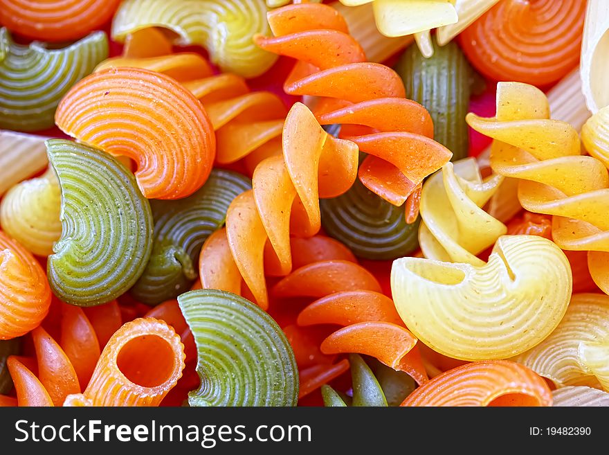Pasta colorful background closeup scattered