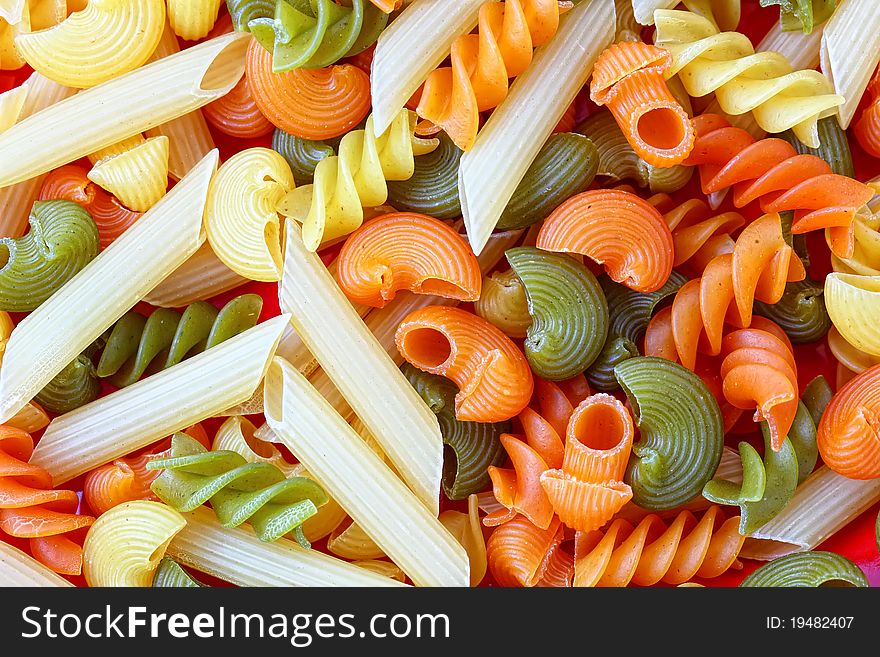 Pasta colorful background closeup scattered