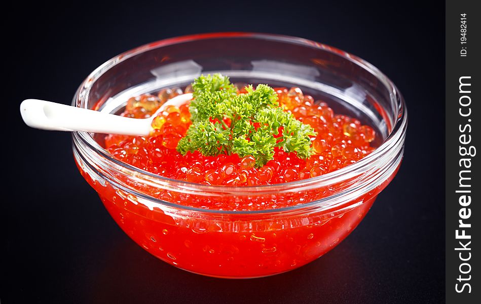 Red caviar on the black background