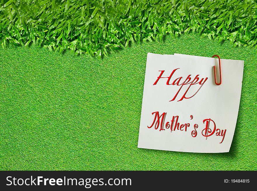 Happy mothers day on green grass for background