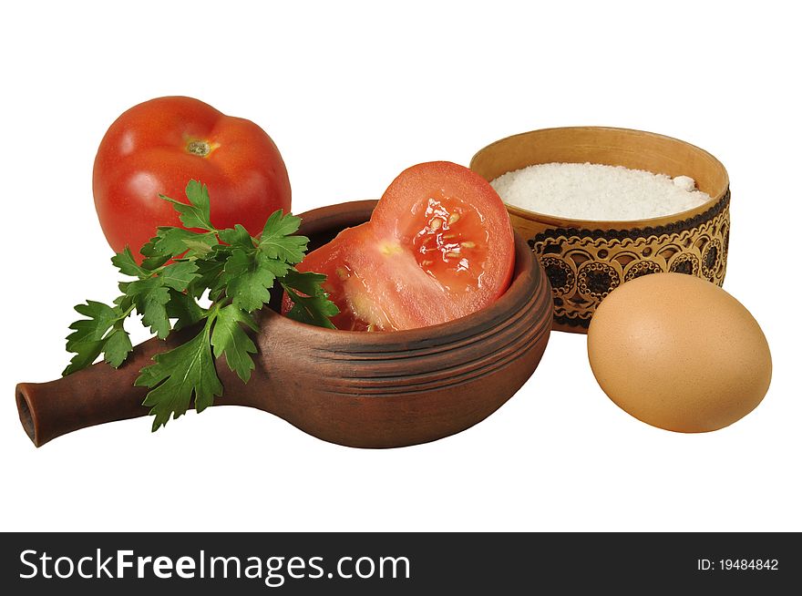 Vegetables and eggs in ceramic ware on the white isolated background