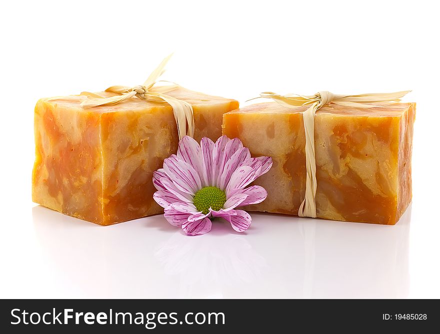 Natural handmade soap and pink flower, on a white background. Natural handmade soap and pink flower, on a white background.