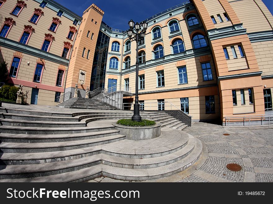 Facade of the building in pastel colors and a stylish lantern