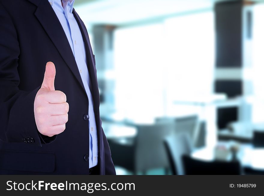 Businessman showing thumb up in front of office