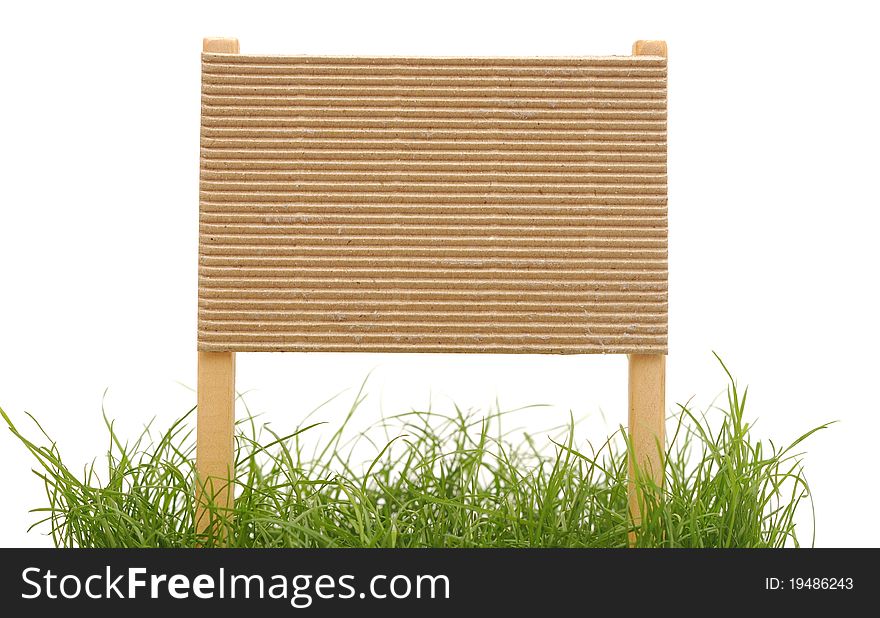 Cardboard sign with grass isolated on a white background