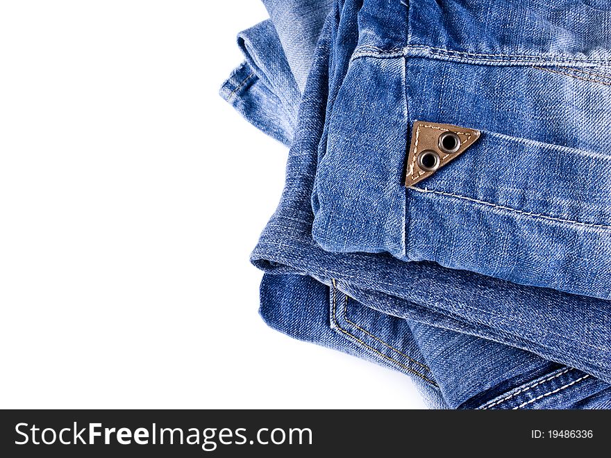 Stack of various shades of blue jeans over white background. Stack of various shades of blue jeans over white background